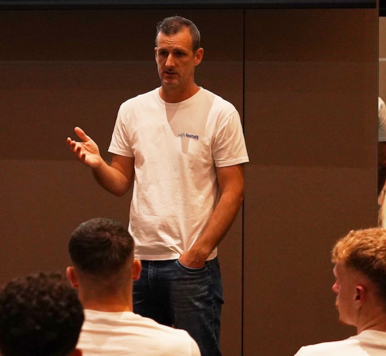 Chris Broadfoot presenting to professional players in a SportsFX t-shirt